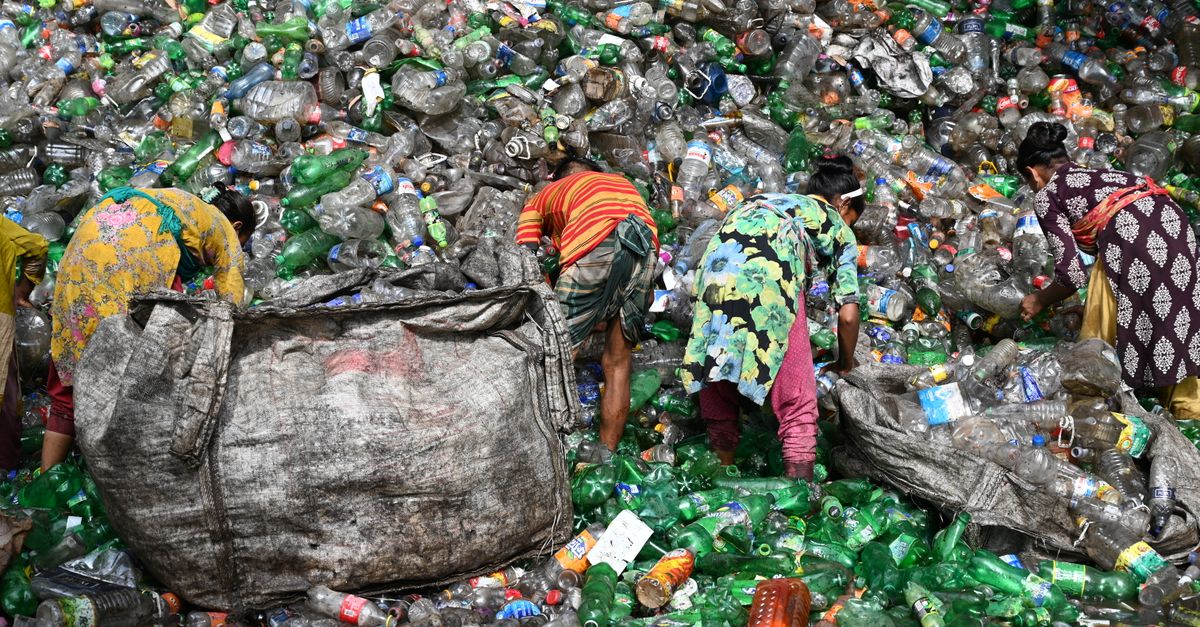 Workers sorting plastic waste at a landfill in Chattogram, Bangladesh. Environmental and recycling theme.
